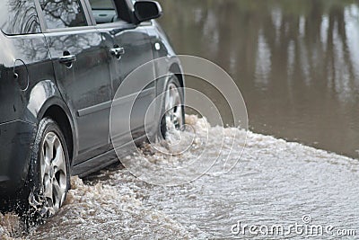 Car Going Through Flood Stock Photo