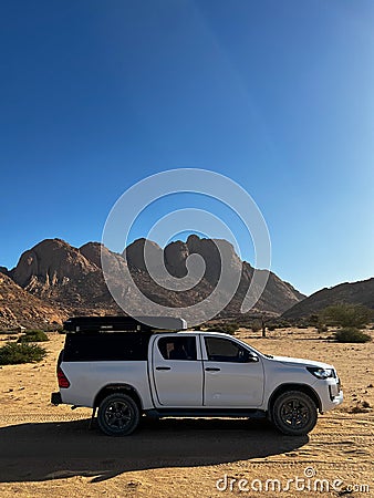 Car on gravel dirt road in desert. Sandy landscape, nobody. SUV. Stock Photo