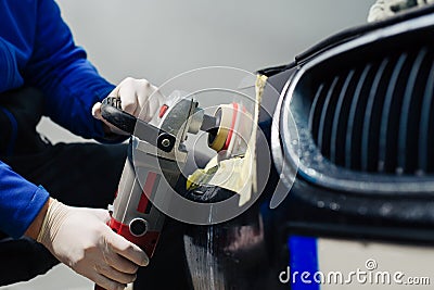 Car headlights cleaning with power buffer machine at car service Stock Photo