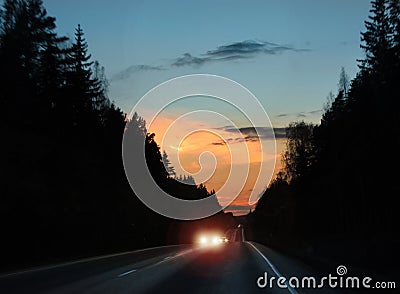 Car headlights glare in evening traffic Stock Photo