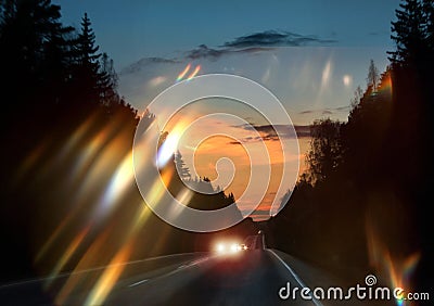 Car headlights glare on windscreen Stock Photo