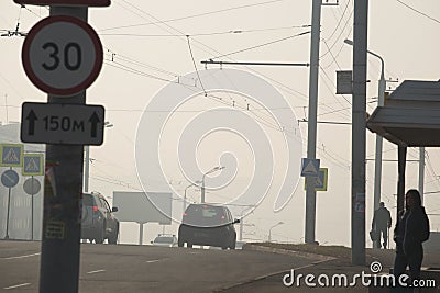 The car highway is in fog in the morning. City of Bratsk. Komsomolskaya Street. Editorial Stock Photo