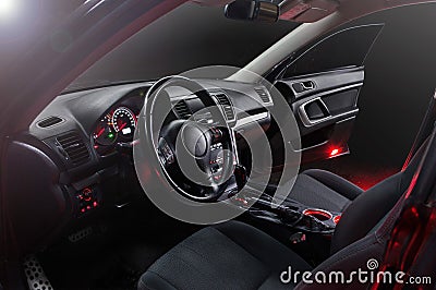 Car inside gray seats red dashboard night photography in the dark Stock Photo