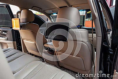 Car inside. Multimedia screens or TV displays for rear passenger seats. Luxury car interior with leather seats Stock Photo