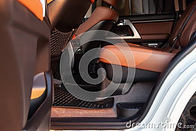 Car inside rear passenger place. Brown interior of prestige modern car. Front seats with steering wheel dashboard. After washing Stock Photo