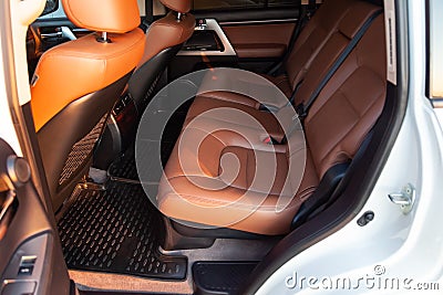 Car inside rear passenger place. Brown interior of prestige modern car. Front seats with steering wheel dashboard. After washing Stock Photo