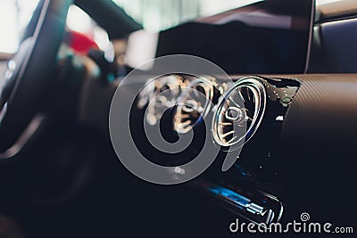 Car interior. Modern car speedometer and illuminated dashboard. Luxurious car instrument cluster. Close up shot of Stock Photo