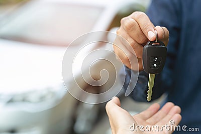 Car key, businessman handing over gives the car key to the other woman Stock Photo