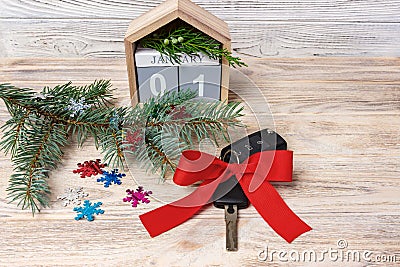 Car key with colorful bow and calendar, christmas tree, branches, snowflakes, on wooden background Stock Photo