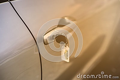 The Car keys inserted on the car door to activate the car Stock Photo