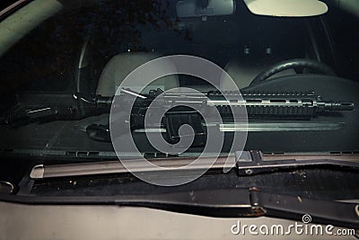 Car left on public with automatic handgun visible behind front window Stock Photo