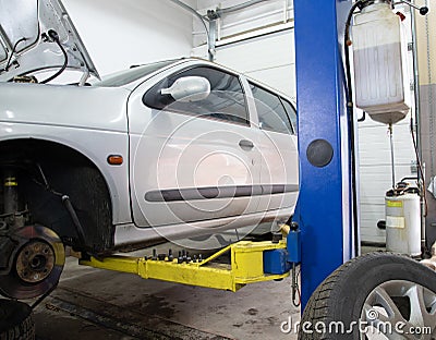 Car on a lift, front wheel removed, service.Car service Stock Photo