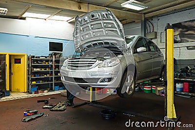 Car on a lift in garage Stock Photo