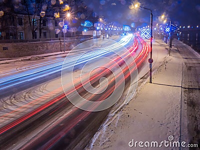 Car light at night on ice road in snow winter Stock Photo