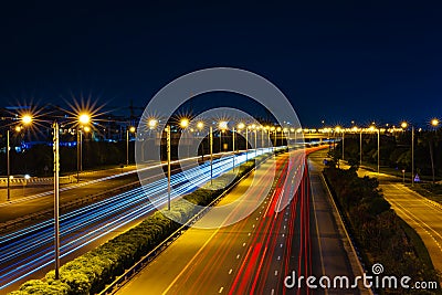 Car light trail on the road at night. Long exposure shot of city light trails captured from Meydan Bridge . Stock Photo