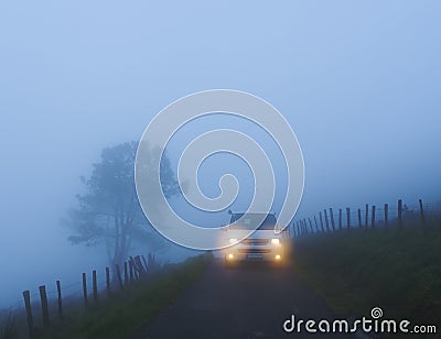 Car with lights on a foggy mountain road, mount Jaizkibel, Euskadi Stock Photo