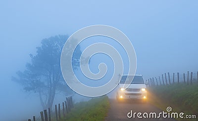 Car with lights on a foggy mountain road, mount Jaizkibel, Euskadi Stock Photo