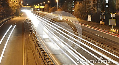 Car lights on german highway construction site with signs at night, long exposure photo of traffic Stock Photo