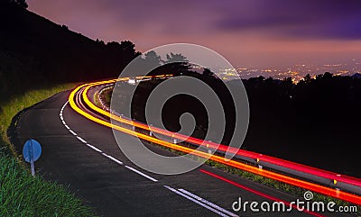 Car lights at night on the road going to the city Editorial Stock Photo