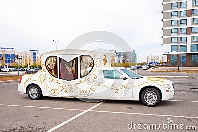 car limousine carriage form in parking. heart shape limousine window. white with gold pattern wedding car limousine side view. Editorial Stock Photo