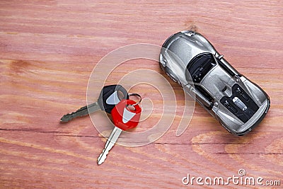 Car Loans, Credit Concepts. Scale Car Along With bunch of Keys Against Vintage Wooden Background Stock Photo