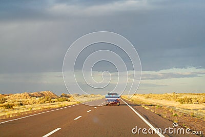 Car on a long road to the sky horizon Stock Photo