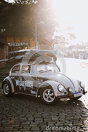 a car with luggage on the roof and other vehicle equipment parked on the side Editorial Stock Photo