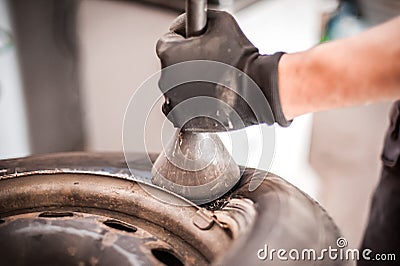 Car master mechanic vulcanizer repairing tire on auto vulcanizing Stock Photo