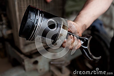 Car mechanic holding piston Stock Photo