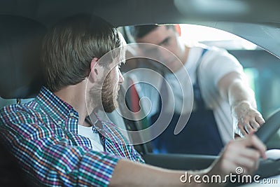 Car mechanic and male driver Stock Photo