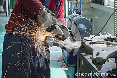 The car mechanic uses an angle grinder to process the frame Stock Photo