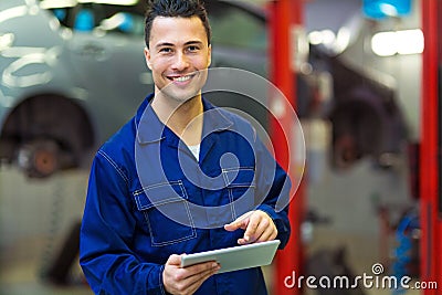 Car mechanic using a digital tablet Stock Photo