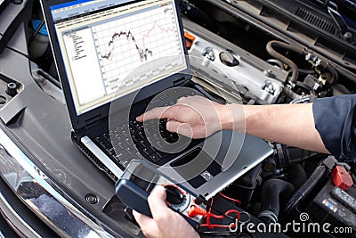 Car mechanic working in auto repair service. Stock Photo