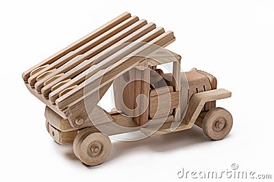 The car is a military toy car made of wood. Stock Photo