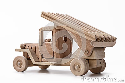 The car is a military toy car made of wood. Stock Photo