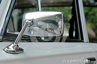 Car mirror in a chrome casing on a gray car Stock Photo