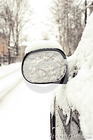 Car mirror covered of snow. Outside Stock Photo