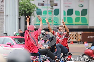 `Car Mob` Protesters a three finger salute to show symbolic gestures between driving vehicles and honk. Editorial Stock Photo