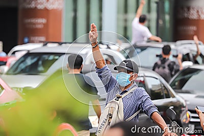 `Car Mob` Protesters a three finger salute to show symbolic gestures between driving vehicles and honk. Editorial Stock Photo