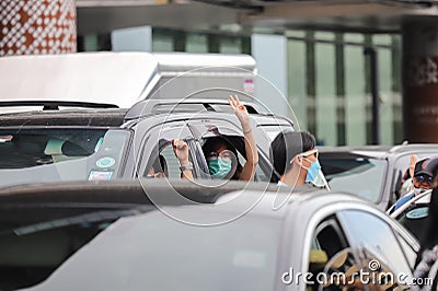 `Car Mob` Protesters a three finger salute to show symbolic gestures between driving vehicles and honk. Editorial Stock Photo