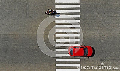 Car and motorcycle crossing a pedestrian crosswalk zebra on a highway Stock Photo