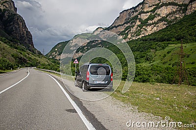 Car among the mountains, by the side of the road Editorial Stock Photo