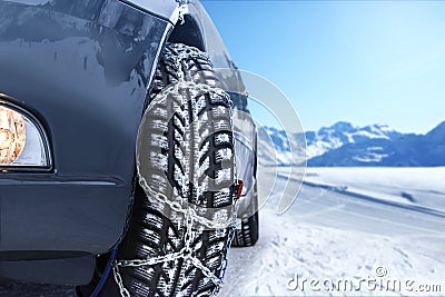 Car with mounted snow chains Stock Photo