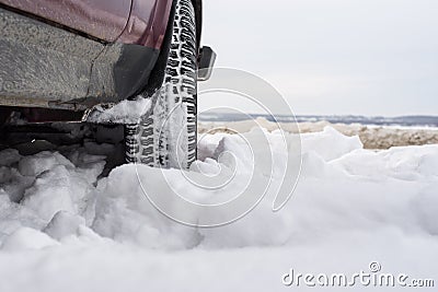Car with mounted snow chains in wintry environment Stock Photo