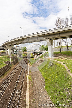 Car overpass running over railway tracks Stock Photo