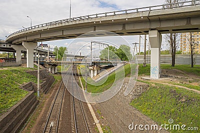 Car overpass running over railway tracks Stock Photo