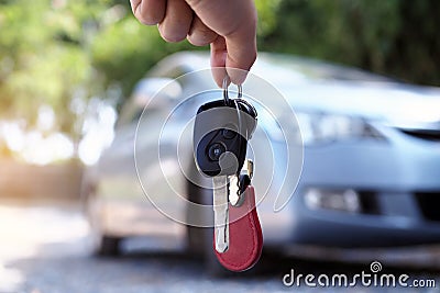 The car owner is standing the car keys to the buyer. Used car sales Stock Photo