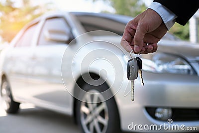 The car owner is standing the car keys to the buyer. Used car sales Stock Photo