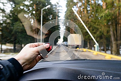 Car park automatic entry system. Man with remote control opens b Stock Photo