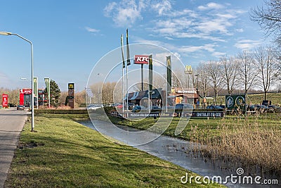 Car park near Dutch motorway with fastfood restaurants Editorial Stock Photo